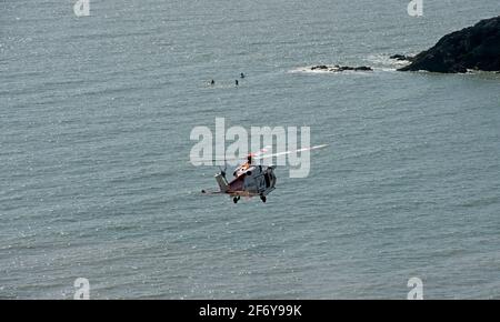 Swansea, UK. 03rd Apr, 2021. A coastguard rescue helicopter lands at Langland Bay, Swansea this afternoon during the hot easter weekend weather. Credit: Phil Rees/Alamy Live News Stock Photo