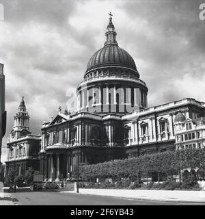 1950s, historical, exterior view of a post-war soot covered St Pauls cathedral, London, England, UK. Designed by Christopher Wren and famous for its dome, it was built in the English baroque style of architecture and stands at Ludgate Hill, the highest point in the City of London. The church of the Bishop of London, construction started in 1675 and at 365 feet was the tallest building in London until 1963. Thankfully the building survived the Blitz of the city during WW2.