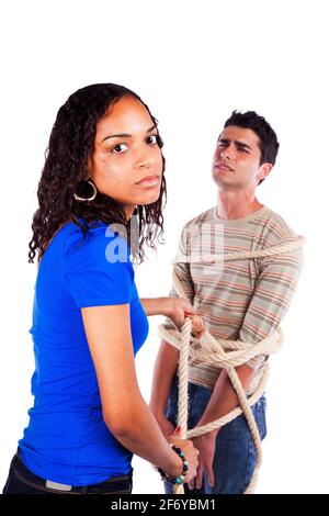 Young woman arresting a youg man with a rope (isolated on white) Stock Photo
