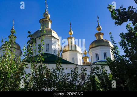 orthodox crosses on gold domes (cupolas) againts blue sky Stock Photo