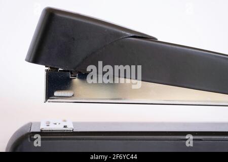 Side view of a black stapler on white background Stock Photo