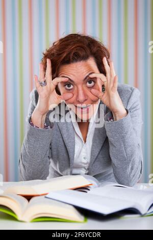 Businesswoman overloaded with work holding her eyes open Stock Photo