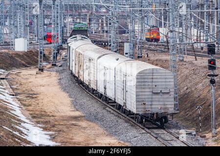 Long freight train approaches to the station. Stock Photo