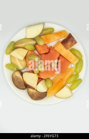 Mumbai , India - 15 March 2021, Fruit salad in the plate on the white background at Mumbai Maharashtra India Stock Photo