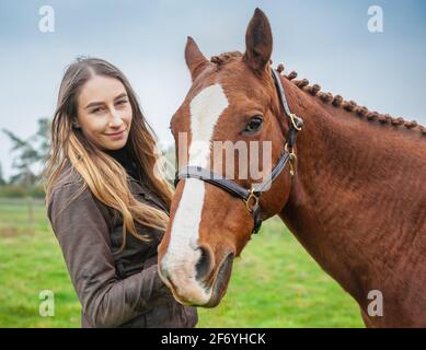 Girl with Chestnut thoroughbred riding horse Stock Photo - Alamy