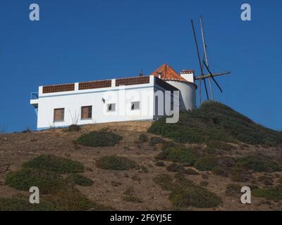 Windmill in beautiful Carraparteira at the Alentejo coast of Portugal Stock Photo