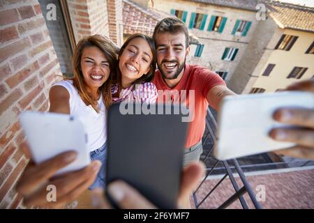 Group of joyful friends taking selfie on a sunny day Stock Photo