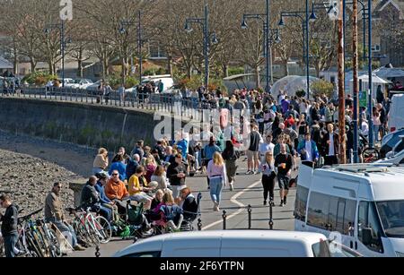 Swansea, UK. 03rd Apr, 2021. Busy scene on the seafront in the small seaside village of Mumbles near Swansea this afternoon as people make the most of the hot easter weekend weather and the Coronavirus lockdown restrictions easing. Credit: Phil Rees/Alamy Live News Stock Photo