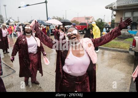 Lady Buckjumpers New Orleans Social Aid and Pleasure Club Second Line (Secondline) Parade dancers on Sunday in the rain. New Orleans, Louisiana, USA. Stock Photo