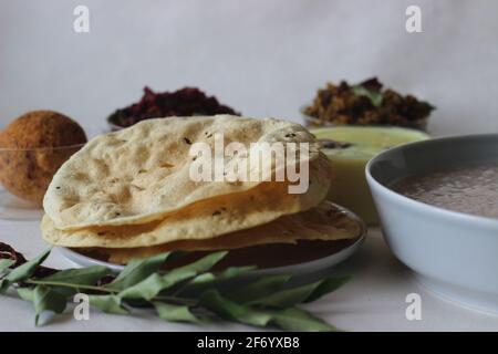 Papadum made with seasoned dough of peeled black gram flour, either fried or cooked with dry heat flipped over an open flame. A perfect side dish for Stock Photo