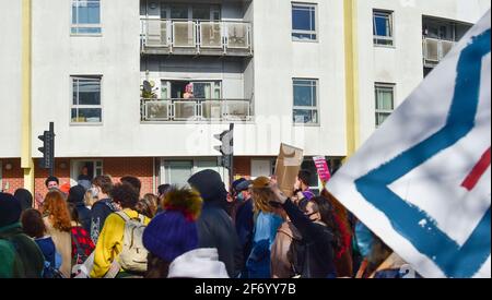 Brighton UK 3rd April 2021 - Residents watch from balconies as hundreds of 'Kill The Bill' protesters march through Brighton in protest against the governments controversial new bill which would give police powers to crack down on peaceful protest  :  Credit Simon Dack / Alamy Live News