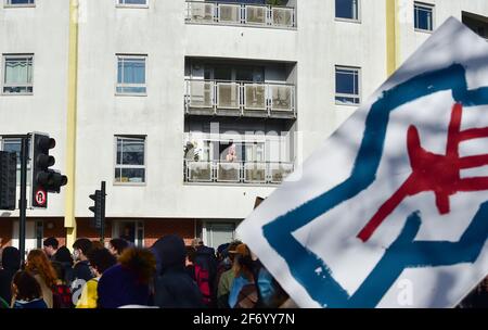Brighton UK 3rd April 2021 - Residents watch from balconies as hundreds of 'Kill The Bill' protesters march through Brighton in protest against the governments controversial new bill which would give police powers to crack down on peaceful protest  :  Credit Simon Dack / Alamy Live News