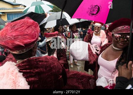 Lady Buckjumpers New Orleans Social Aid and Pleasure Club Second Line (Secondline) Parade dancers on Sunday in the rain. New Orleans, Louisiana, USA. Stock Photo