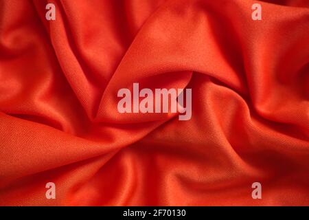 Red crumpled fabric texture background. Close up. Stock Photo