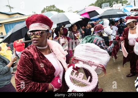 Lady Buckjumpers New Orleans Social Aid and Pleasure Club Second Line (Secondline) Parade dancers on Sunday in the rain. New Orleans, Louisiana, USA. Stock Photo