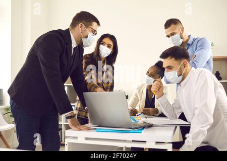 Creative business team meeting after lockdown in new normal safe office Stock Photo