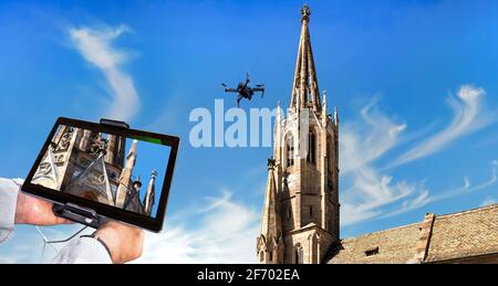 Drone in the air inspecting church tower and ornaments. Close-up of display with defective embellishments Stock Photo