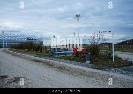 Allianz Arena during the Corona Lockdown. Where tourists and fans usually bustle about, craftsmen and employees work, there is yawning emptiness.. Stock Photo