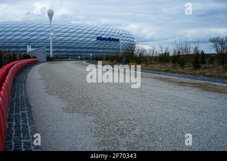 Allianz Arena during the Corona Lockdown. Where tourists and fans usually bustle about, craftsmen and employees work, there is yawning emptiness.. Stock Photo