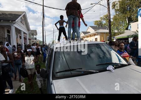 Kids dancing on cars during Prince of Wales, New Orleans Social Aid and Pleasure Club Second Line (Secondline) Second Line Sunday parade, New Orleans. Stock Photo