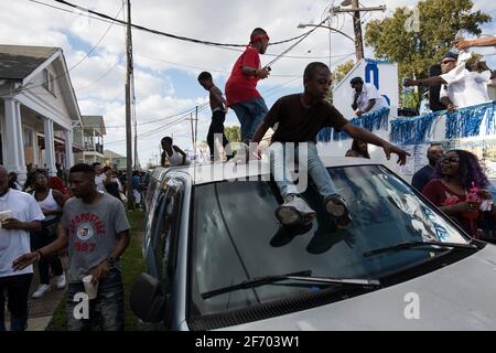 Kids dancing on cars during Prince of Wales, New Orleans Social Aid and Pleasure Club Second Line (Secondline) Second Line Sunday parade, New Orleans. Stock Photo