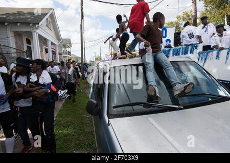 Kids dancing on cars during Prince of Wales, New Orleans Social Aid and Pleasure Club Second Line (Secondline) Second Line Sunday parade, New Orleans. Stock Photo