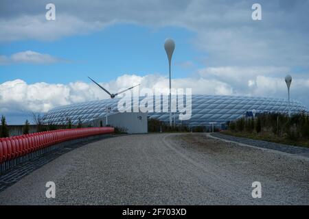 Allianz Arena during the Corona Lockdown. Where tourists and fans usually bustle about, craftsmen and employees work, there is yawning emptiness.. Stock Photo