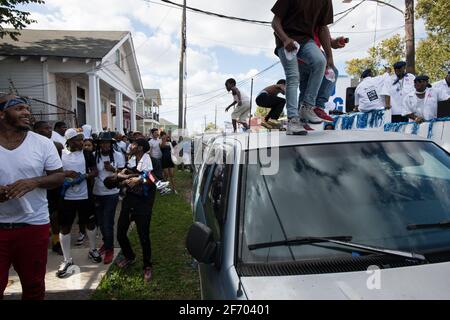 Kids dancing on cars during Prince of Wales, New Orleans Social Aid and Pleasure Club Second Line (Secondline) Second Line Sunday parade, New Orleans. Stock Photo