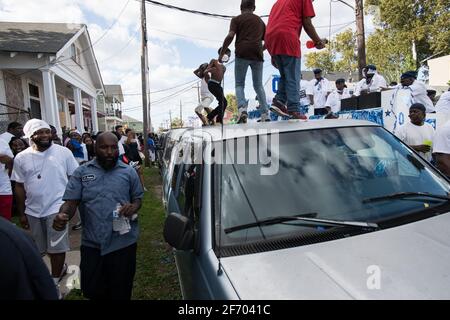 Kids dancing on cars during Prince of Wales, New Orleans Social Aid and Pleasure Club Second Line (Secondline) Second Line Sunday parade, New Orleans. Stock Photo