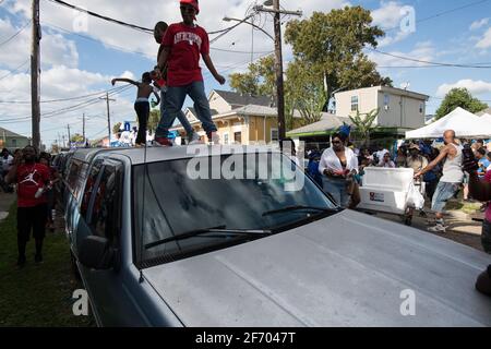 Kids dancing on cars during Prince of Wales, New Orleans Social Aid and Pleasure Club Second Line (Secondline) Second Line Sunday parade, New Orleans. Stock Photo