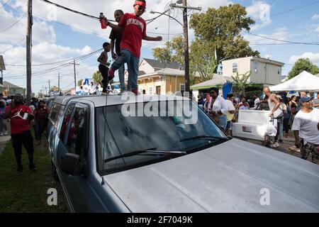 Kids dancing on cars during Prince of Wales, New Orleans Social Aid and Pleasure Club Second Line (Secondline) Second Line Sunday parade, New Orleans. Stock Photo