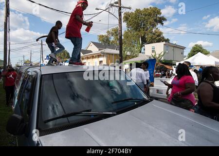 Kids dancing on cars during Prince of Wales, New Orleans Social Aid and Pleasure Club Second Line (Secondline) Second Line Sunday parade, New Orleans. Stock Photo