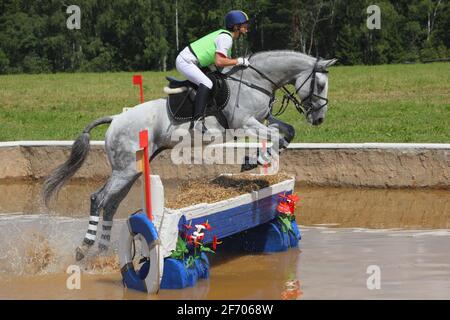 Three day event rider taking part in the cross country Phase Stock Photo