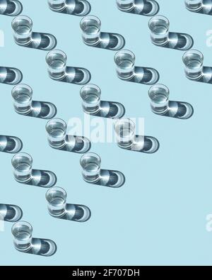 Pattern from glasses with water on a blue background. Ecological concept. Stock Photo