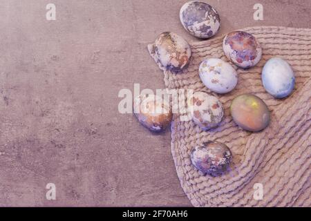 Happy Easter eggs with marble stone effect painted with natural grey concrete background with blank space for text. top view, flat lay Stock Photo