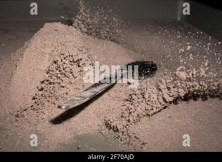 Cocoa splash with a spoon, studio shot Stock Photo