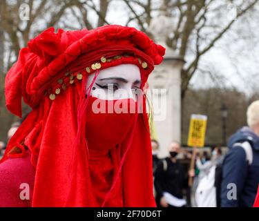 London, UK. 03rd Apr, 2021. A Red Rebel, part of Extinction Rebellion's protest group, joins the Kill The Bill protest march in Hyde Park, London. Anna Hatfield/ Pathos Images Credit: One Up Top Editorial Images/Alamy Live News