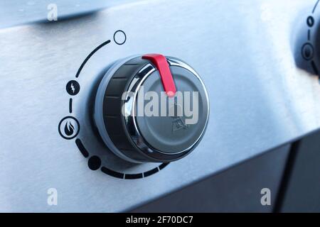 Grill knob gas power heat temperature starter lighter chrome cook appliance on off Stock Photo