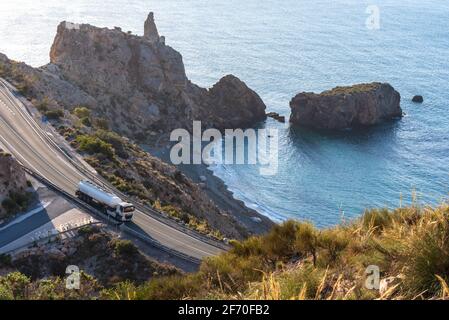 Fuel tanker driving on a mountain road by the sea. Stock Photo