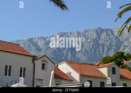 MAKARSKA, CROATIA - JUNE 17: Building on mountains background in Makarska, Croatia on June 17, 2019. Stock Photo