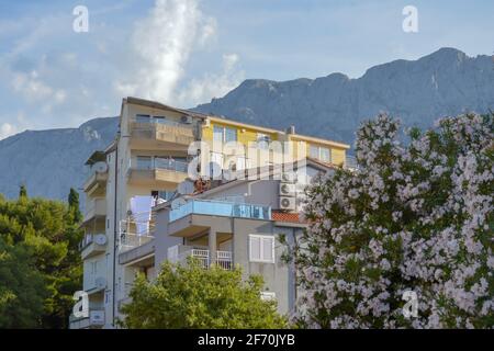 MAKARSKA, CROATIA - JUNE 17: Building on mountains background in Makarska, Croatia on June 17, 2019. Stock Photo