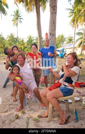 Filipino family and friends enjoying the beach together and a few drinks. Santa Fe, Bantayan Island, Cebu, Philippines Stock Photo