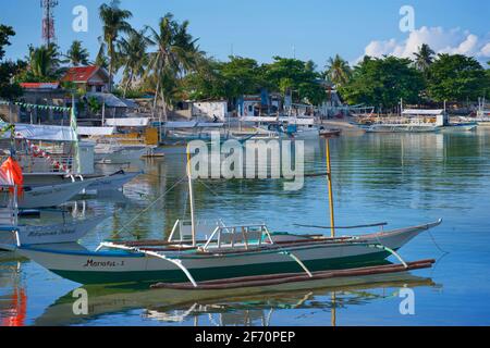 Logon, Malapascua Island. Outrigger canoe moored in the bay. Visayan Sea, Cebu, Philippines. Stock Photo