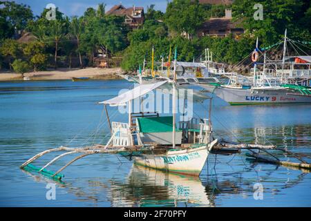 Logon, Malapascua Island. Outrigger canoe moored in the bay. Visayan Sea, Cebu, Philippines. Stock Photo