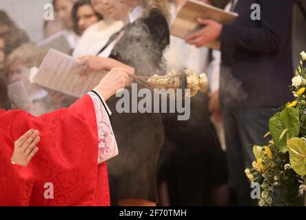 The bishop grants the Sacrament of Confirmation in a large Christian Church Stock Photo