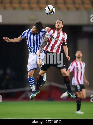 Seville, Spain. 3rd Apr, 2021. David Silva (L) of Real Sociedad vies with Iker Muniain of Bilbao during the Spanish King's Cup final match between Athletic Club Bilbao and Real Sociedad in Seville, Spain, on April 3, 2021. The game is the rescheduled final of the 2019-2020 competition which was originally postponed due to the coronavirus pandemic. Credit: Pablo Morano/Xinhua/Alamy Live News Stock Photo