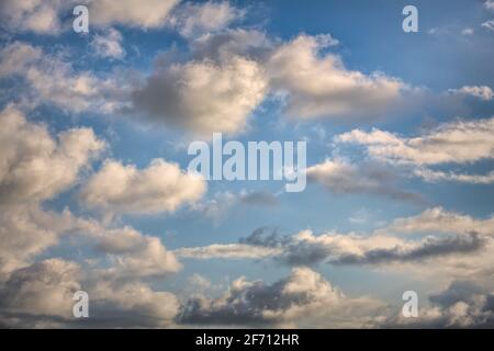 White Cumulus Clouds White And Fluffy Sit In A Blue Daytime Sky Stock Photo