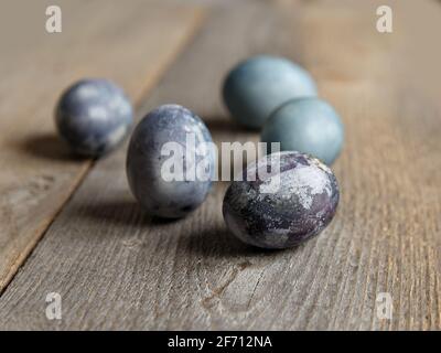 Painted chicken eggs on surface of wooden planks. Selective focus Stock Photo