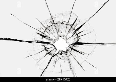 Cracks in the window from a shot from a weapon. Damaged window glass. Stock Photo