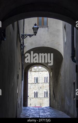 ancient arch of the stone gate in the medieval walls of the historic city Stock Photo